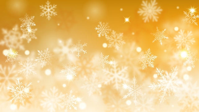Christmas blurred background of complex defocused big and small falling snowflakes in yellow colors with bokeh effect