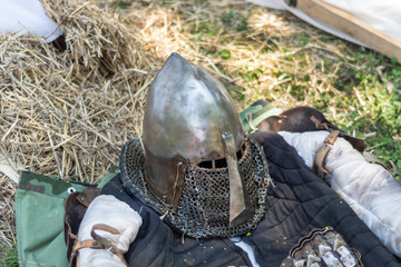 Medieval metal helmet on the floor. Old dark ages armor and equipment for knights head protection...