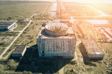 Abandoned and ruined Nuclear Power Plant in Shelkino, Crimea. Industrial construction with round...