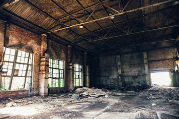 Fototapeta na wymiar Abandoned ruined industrial warehouse or factory building, corridor view with perspective, ruins and demolition concept