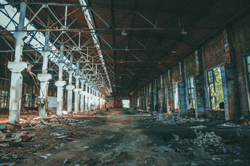 Dramatic ruined and abandoned industrial building, creepy corridor view, perspective