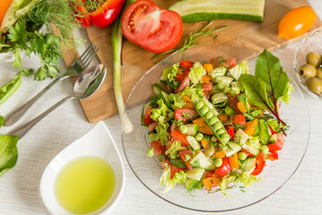Plate with fresh vegetables salad with olive oil. Vegan vegetarian healthy food	