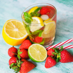 Fototapeta na wymiar Sweet water with strawberry, mint leaves, lemon and lime. Refreshing summer soft drink with fresh fruits.