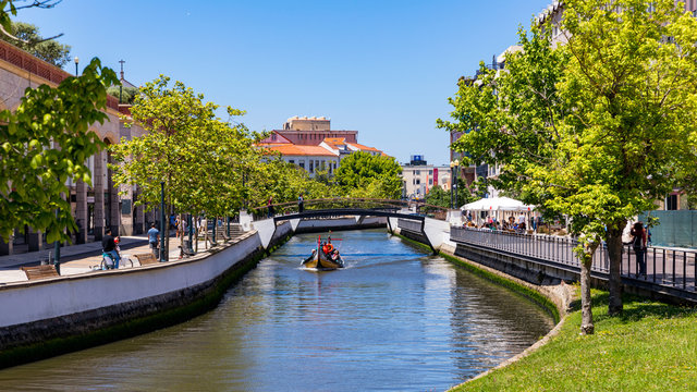 Aveiro, Portugal - June 16, 2018: Traditional boats on the canal in Aveiro, Portugal. Colorful Moliceiro boat rides in Aveiro are popular with tourists to enjoy views of the charming canals.