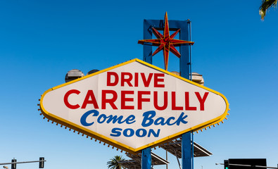 The backside of the famous Las Vegas sign reading "drive carefully, come back soon"
