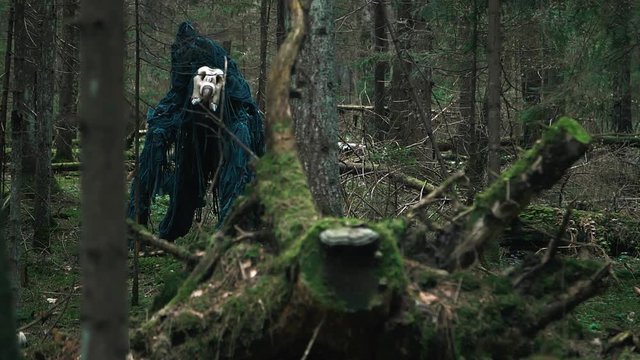 Horrible creature standing among trees in forest. Terrible monster
