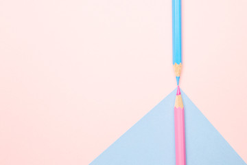 Minimal creative color pencils crayon geometry flat lay top view background with blue and pink colors pencil