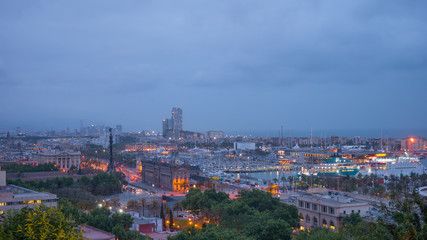 Night in the city of Barcelona in Catalonia, Spain. Columbus Monument and boulevard along Port Vell.