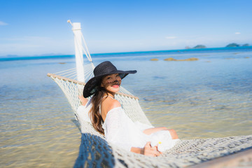 Portrait beautiful young asian woman sitting on hammock around sea beach ocean for relax