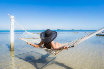 Portrait beautiful young asian woman sitting on hammock around sea beach ocean for relax