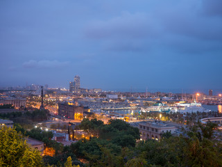 Night in the city of Barcelona in Catalonia, Spain. Columbus Monument and boulevard along Port Vell.