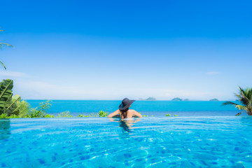 Portrait beautiful young asian woman relax in luxury outdoor swimming pool in hotel resort nearly beach sea ocean