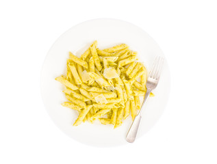 White plate with pasta and pesto