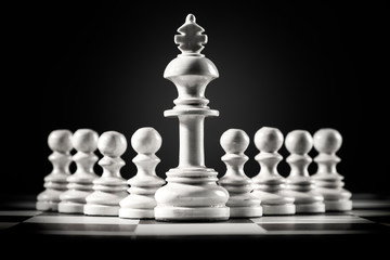 White king chess standing in front of the pawn chess
