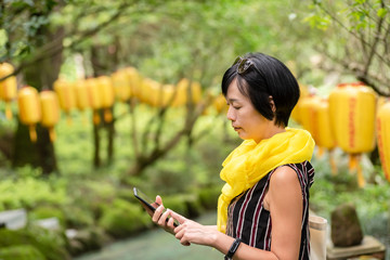 mature Asian woman talking on cellphone
