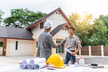 Shaking hands while working in the office center, Asian people.