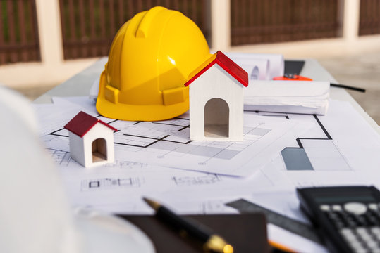 Architect Desk With Blueprint And Hard Hat Constuction Building.