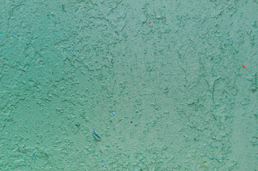 Texture of iron metal painted bright green peeling paint of old battered scratched cracked ancient rusty metal sheet wall with corrosion. The background