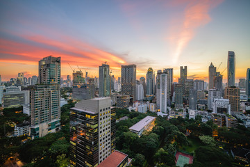 Modern office buildings and condominiums in Bangkok metropolis with sunset sky and clouds at Bangkok , Thailand.