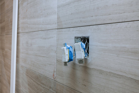 White Installation Electric Switch With Connecting Wires On Bathroom Interior Light Wall