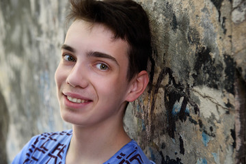 Portrait of teenage boy near the wall on the street