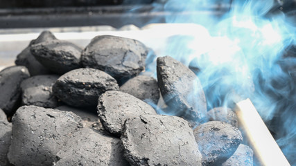 charcoal baguettes being lit for barbecue grill