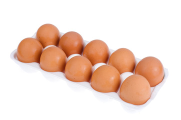 Chicken brown eggs and egg yolk in white form. 