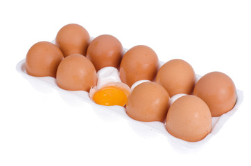 Chicken brown eggs and egg yolk in white form. 