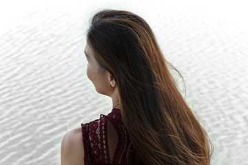 30-40s adult portrait behind of woman long hair with white wave water lake background