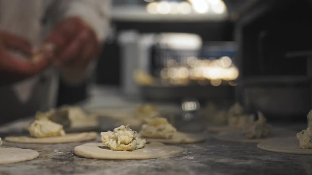 CLOSEUP footage of cooks preparing panzerotti at italian restaurant