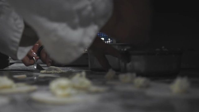 CLOSEUP footage of cooks preparing panzerotti at italian restaurant