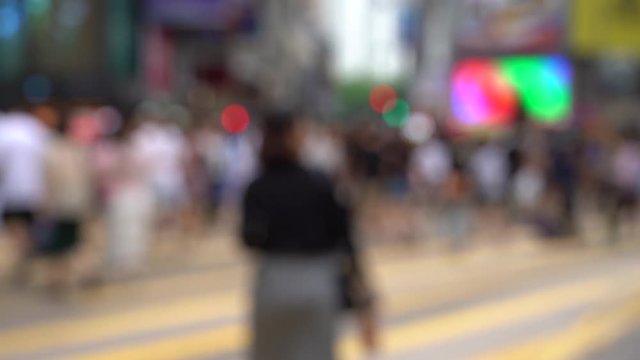 Blurred crowd of people on Hong Kong busy crosswalk; Slow Motion