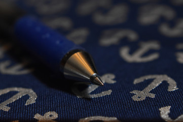 ink pen on a blue anchor background