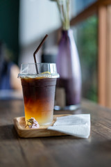 Cold black coffee drinks placed on a wooden table