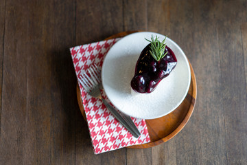 Blueberry cake in a plate placed on a wooden table