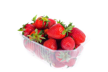 Fresh sweet red strawberries in plastic container. 