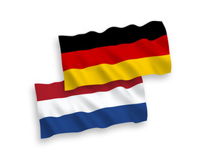 National vector fabric wave flags of Germany and Netherlands isolated on white background. 1 to 2 proportion.