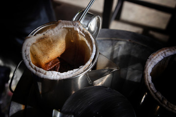 coffee boiler in vintage Thai traditional basket on metal