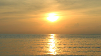 Fototapeta premium fisherman sailing and sunset on the sea