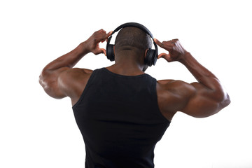 Athlete bodybuilder with beautiful torso, isolated on white background. African American listening...
