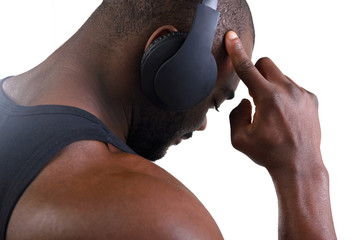 Athlete bodybuilder with beautiful torso, isolated on white background. African American listening...