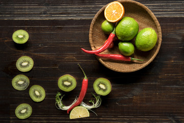 Colorful of Healthy fruit on wooden table. Chili , lemon, tomato, Kiwi, Multi fresh fruits on background. Royalty high quality free stock image.