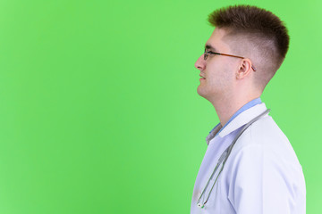 Closeup profile view of young handsome man doctor