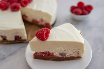 Cheesecake slice with raspberries on a plate