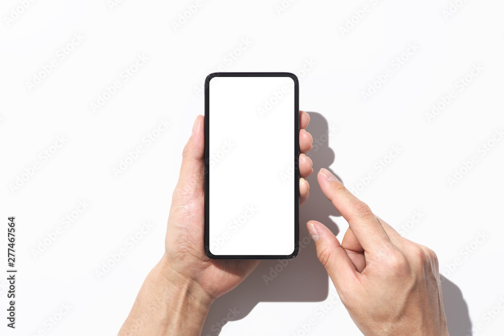 Poster closeup of hands touching black smartphone on white background with shadow. blank screen.