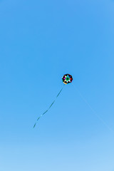 Handmade kite flying with a blue sky background