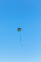 Handmade kite flying with a blue sky background