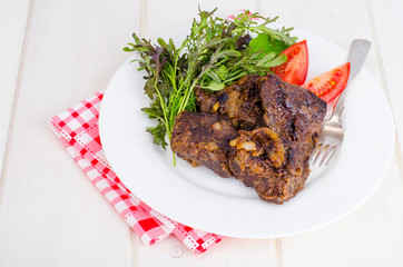 Fried beef liver with lettuce mix. 