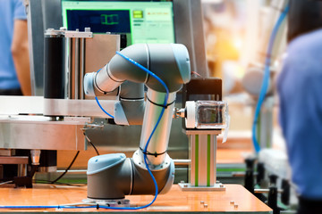 Robotic arm machine in factory picked up the Plastic bottle packaging to barcode scanner machine. Technology and Global logistics robots market in future concept.