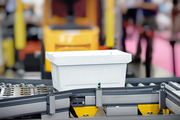 Fototapeta premium Plastic crate for raw material loading on conveyor machine in the warehouse.